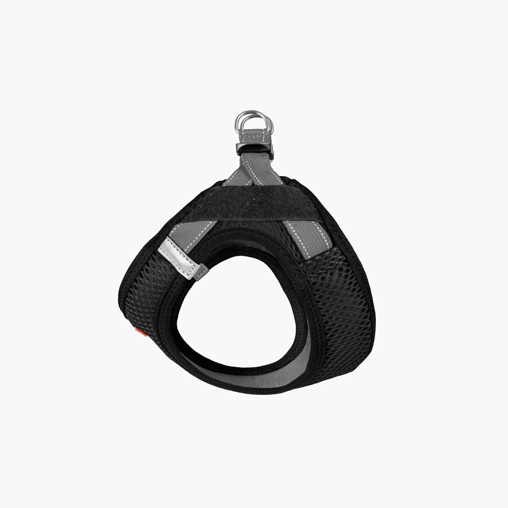 Front view of a black EzyDog harness with adjustable straps and a metal ring for leash attachment.