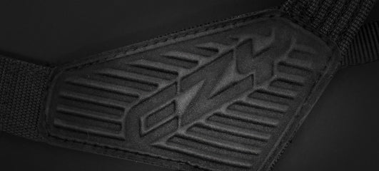 Close-up of the black EzyDog harness buckle with embossed logo and textured design.